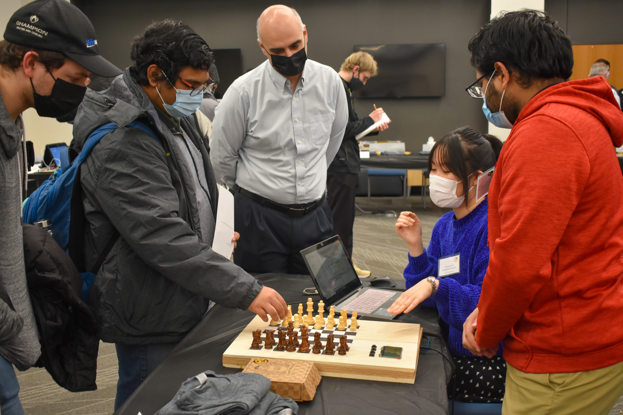Chess board with team presenting while judges and guests listen